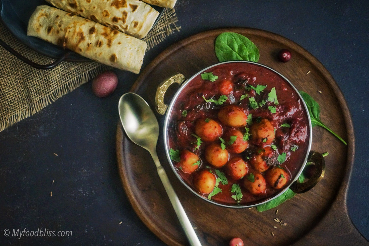 Baby potatoes in cranberry gravy with chunky spinach-vegan